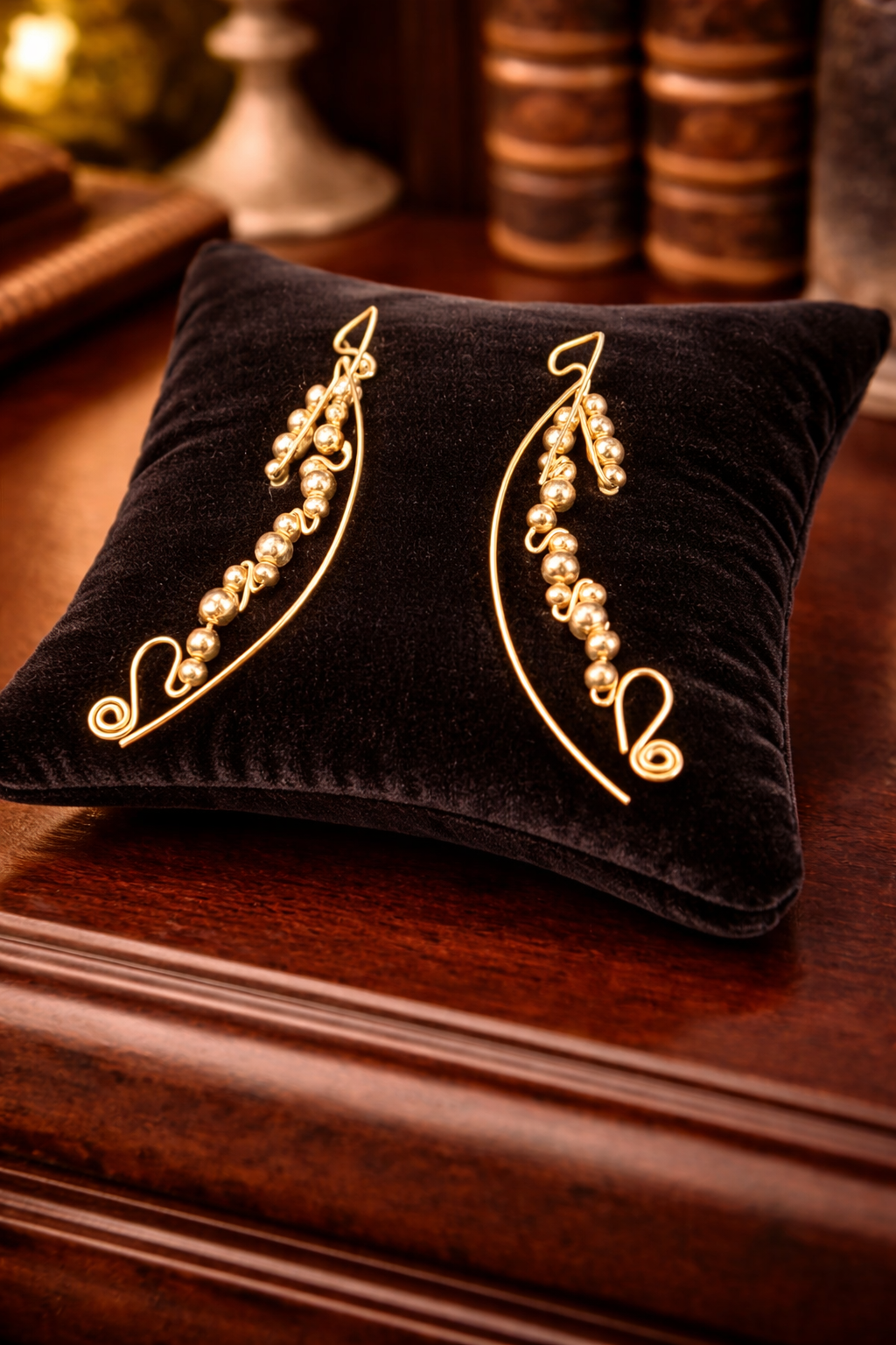 Gold tone bead swirl wire earrings with curved drop design
