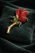 Vintage Monet Gold-Tone Red Rhinestone Rose Brooch with Green Enamel Leaves