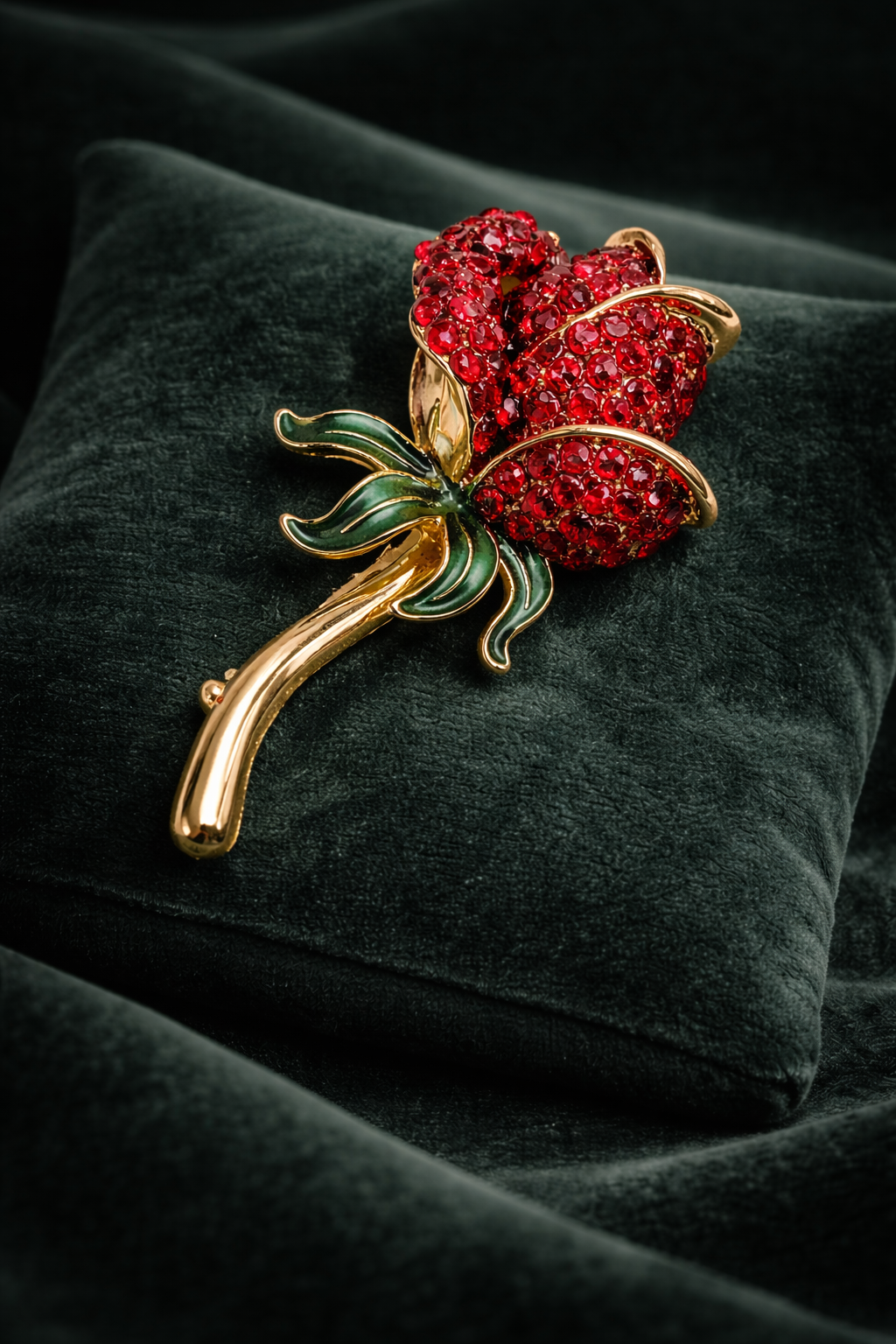 Vintage Monet Gold-Tone Red Rhinestone Rose Brooch with Green Enamel Leaves