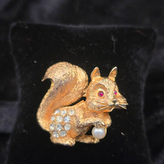Gold tone squirrel brooch with rhinestone acorns and faux pearl detail