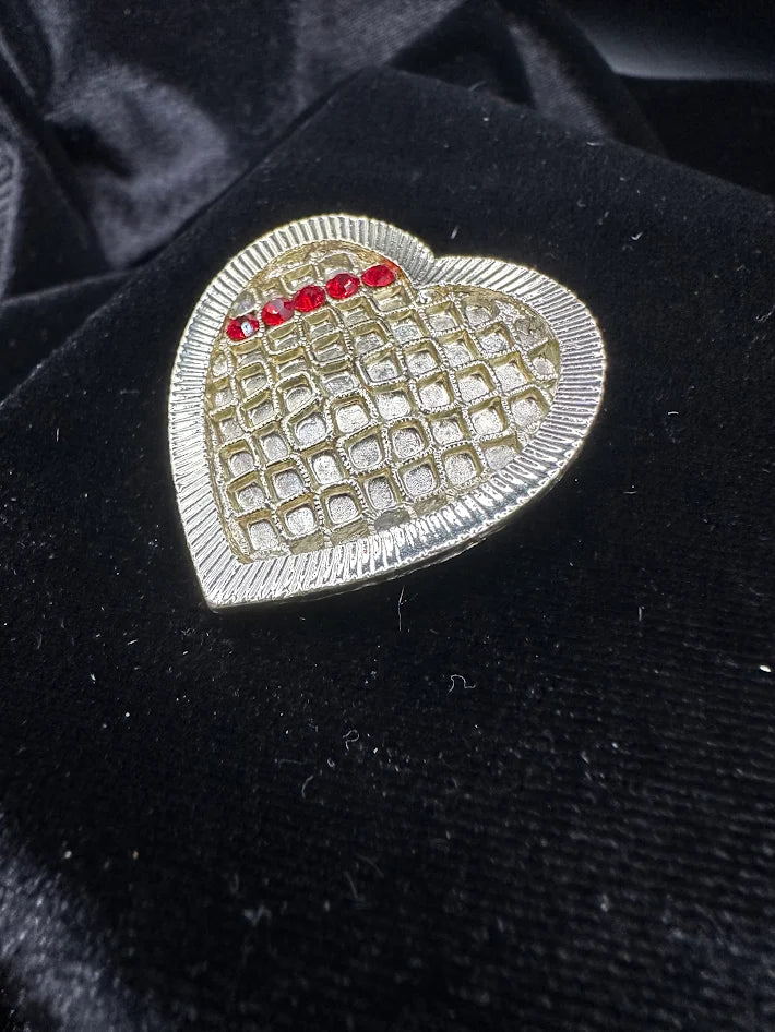 Pale Gold tone heart brooch with red rhinestones and textured lattice design
