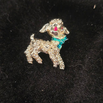Gold tone lamb brooch with textured finish and teal bow detail