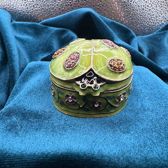 Green ladybug trinket box with floral trim and rhinestone accents