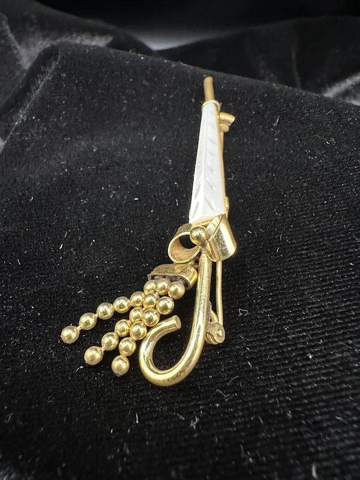 Gold tone umbrella brooch with white carved look panel and bead tassel detail