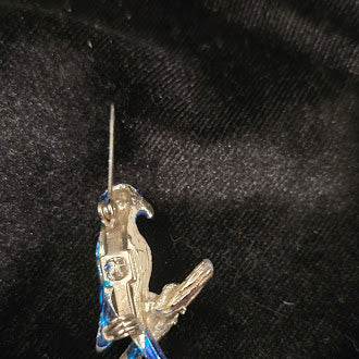 Blue enamel parrot brooch on branch with gold tone trim