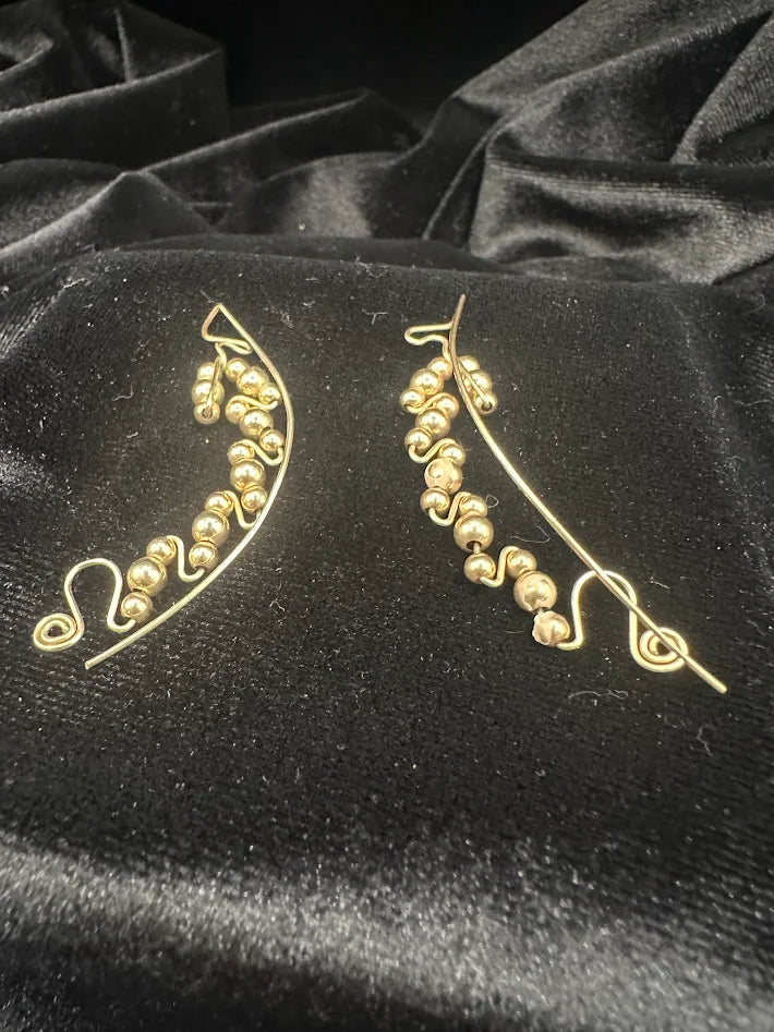 Gold tone bead swirl wire earrings with curved drop design