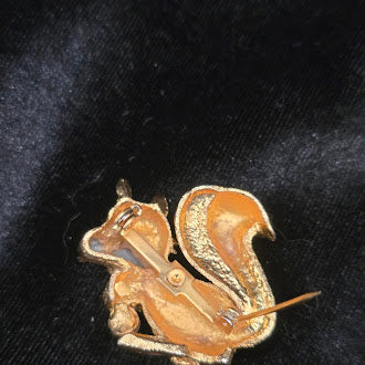 Gold tone squirrel brooch with rhinestone acorns and faux pearl detail