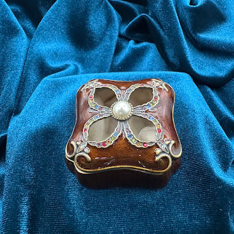 Mahogany tone enameled trinket box with jeweled quatrefoil lid and pearl accent