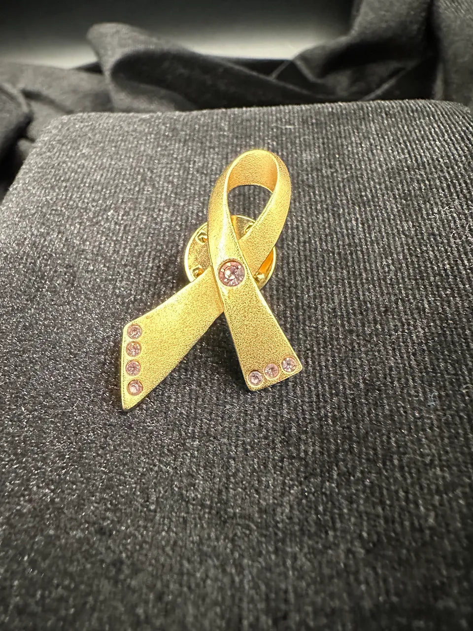 Avon Gold Tone Pink Crystal Ribbon Brooch with Textured Awareness Ribbon Design