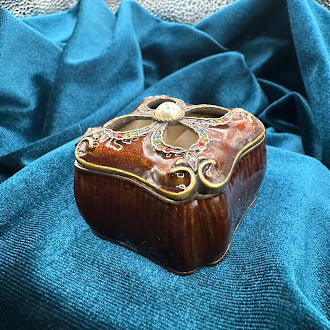 Mahogany tone enameled trinket box with jeweled quatrefoil lid and pearl accent
