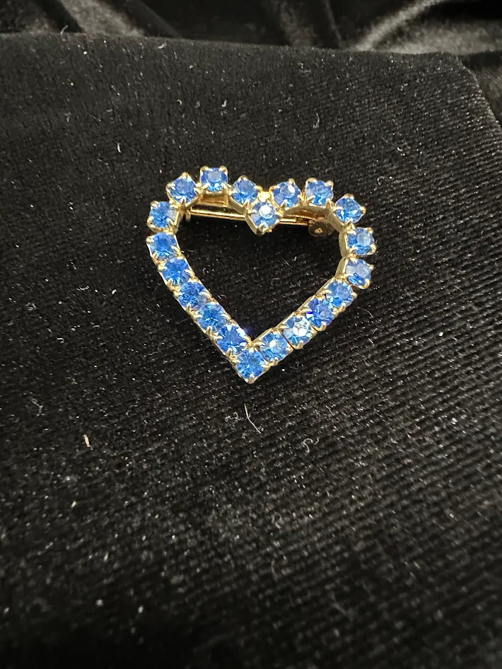 Gold tone open-heart brooch with blue rhinestones