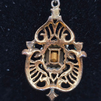 Gold tone filigree pendant necklace with blue crystal and faux pearl frame