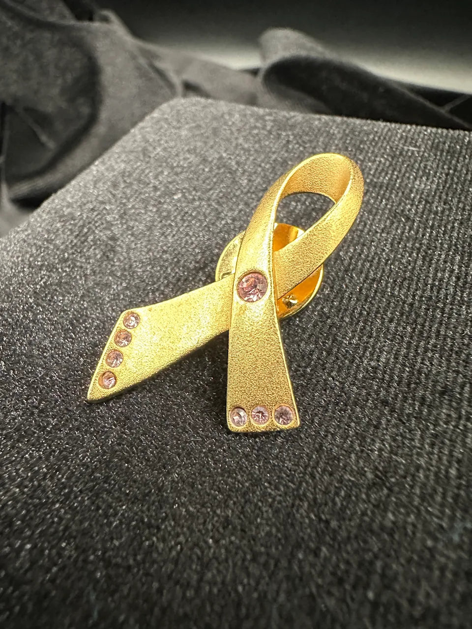 Avon Gold Tone Pink Crystal Ribbon Brooch with Textured Awareness Ribbon Design