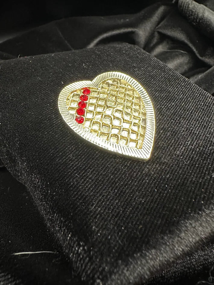 Pale Gold tone heart brooch with red rhinestones and textured lattice design