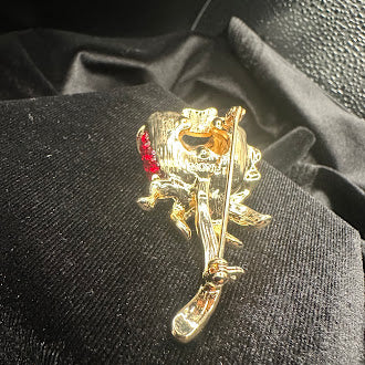 Vintage Monet Gold-Tone Red Rhinestone Rose Brooch with Green Enamel Leaves