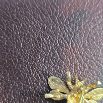 CINI gold tone insect brooch with green crystal bodySigned CINI Sterling Silver Vermeil Bee Brooch with Emerald Green Faceted Stone, Mid Century Designer Insect Pin